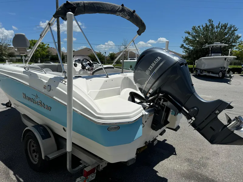 Slide: The Image of 2022 NauticStar 193SC boat with Yamaha outboard motor on trailer, parked outdoors. - 16