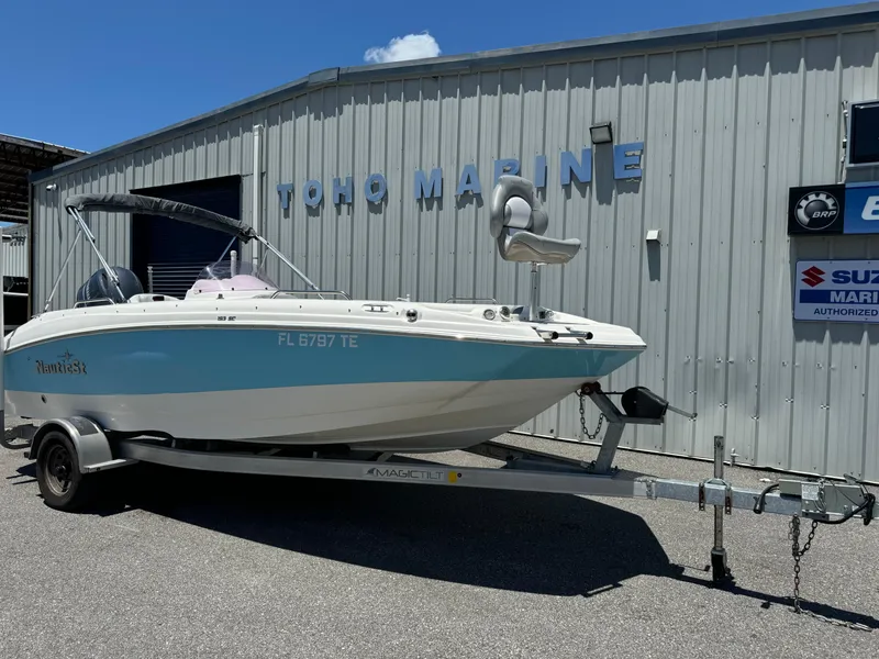 Slide: The Image of 2022 NauticStar 193SC boat on trailer outside marine dealership. - 2