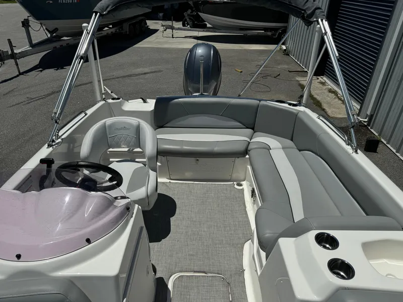 Slide: The Image of 2022 NauticStar 193SC boat interior with gray seating and steering wheel. - 8