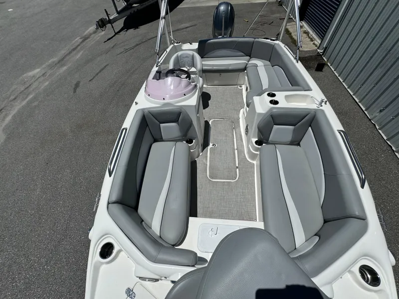 Slide: The Image of 2022 NauticStar 193SC boat interior with gray seating and steering console. - 9
