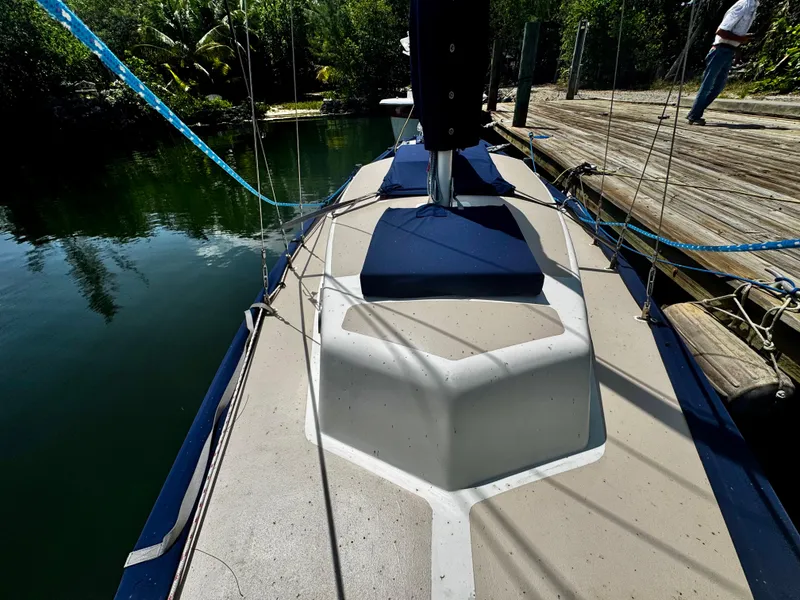Slide: The Image of 1968 Sailboat 24 docked, showing deck and rigging in a serene marina setting. - 8