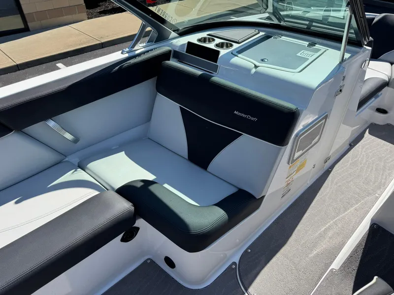 Slide: The Image of 2020 MasterCraft XT22 boat interior with black and white seating and cup holders. - 10