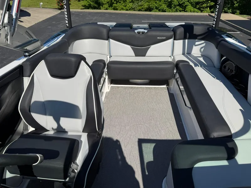 Slide: The Image of 2020 MasterCraft XT22 boat interior with sleek black and white seating design. - 12