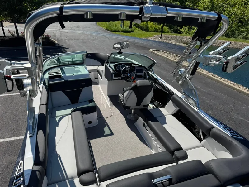 Slide: The Image of 2020 MasterCraft XT22 boat interior with sleek seating and modern dashboard. - 13
