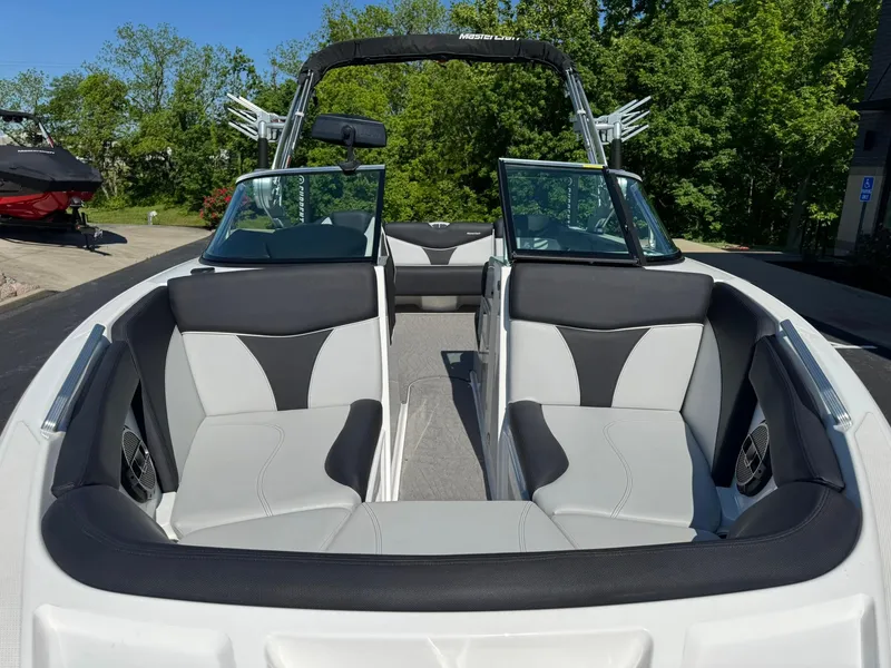 Slide: The Image of 2020 MasterCraft XT22 boat interior with sleek seating and open bow design. - 16