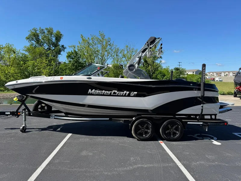 Slide: The Image of 2020 MasterCraft XT22 boat on trailer in parking lot, sunny day. - 5