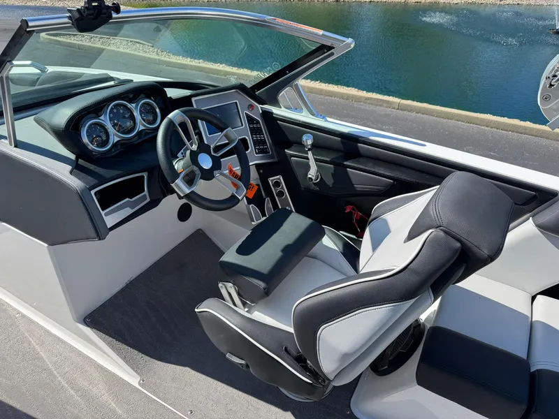 Slide: The Image of 2020 MasterCraft XT22 boat interior with modern dashboard and comfortable seating. - 9