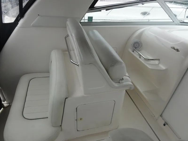 Slide: The Image of 1997 Sea Ray 330 Express boat interior with white seating and dashboard. - 12