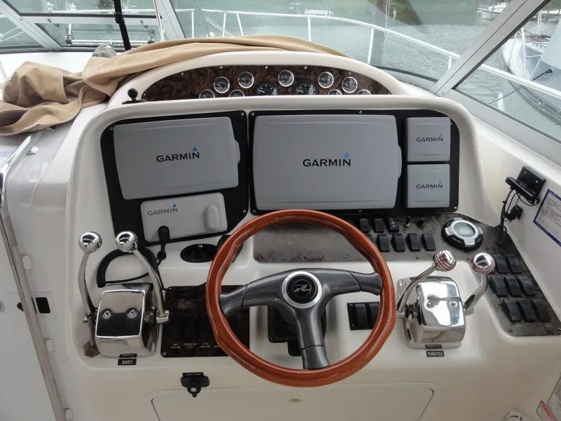 Slide: The Image of 1997 Sea Ray 330 Express helm with Garmin navigation system and wooden steering wheel. - 14