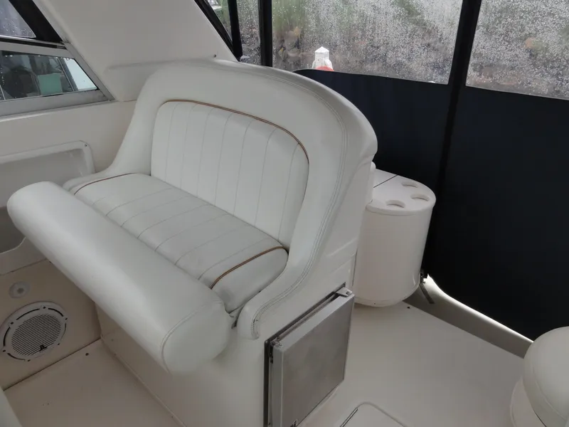Slide: The Image of 1997 Sea Ray 330 Express interior with white seating and cup holders. - 15