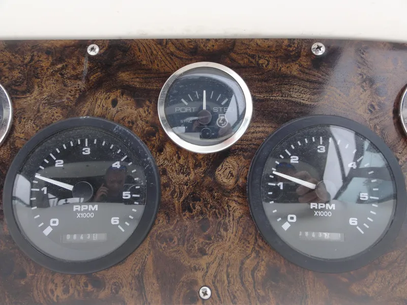 Slide: The Image of Dashboard of a 1997 Sea Ray 330 Express boat with RPM gauges and wood finish. - 20