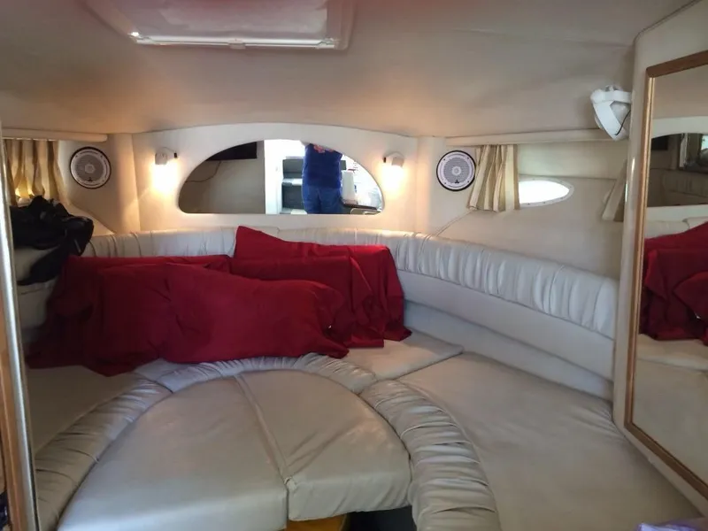 Slide: The Image of Interior of 1997 Sea Ray 330 Express with white seating and red blanket. - 23