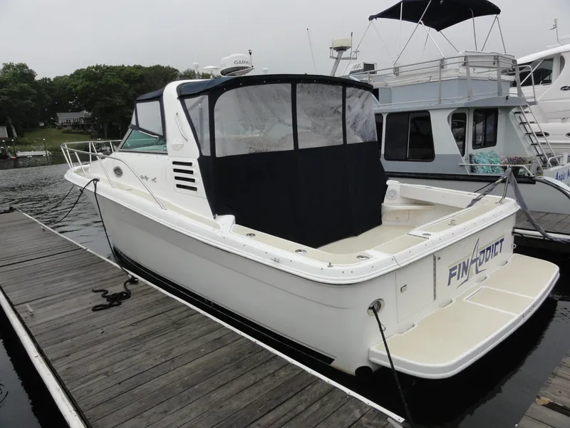 Slide: The Image of 1997 Sea Ray 330 Express boat docked at marina, rear view. - 3