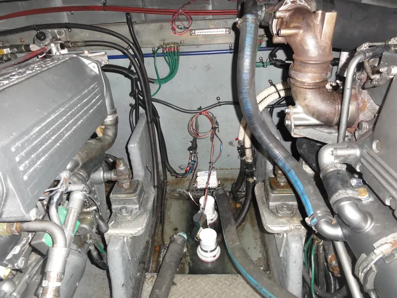 Slide: The Image of Engine compartment of a 1997 Sea Ray 330 Express boat, showing mechanical components and wiring. - 31