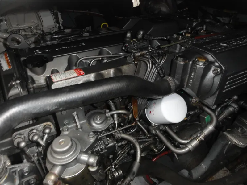 Slide: The Image of Engine compartment of a 1997 Sea Ray 330 Express boat, showcasing intricate mechanical components. - 32