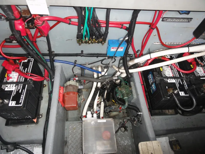 Slide: The Image of 1997 Sea Ray 330 Express engine compartment with batteries and wiring. - 34