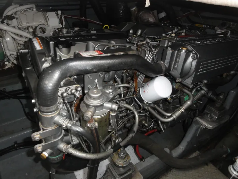 Slide: The Image of Engine compartment of a 1997 Sea Ray 330 Express boat, showcasing intricate mechanical components. - 37