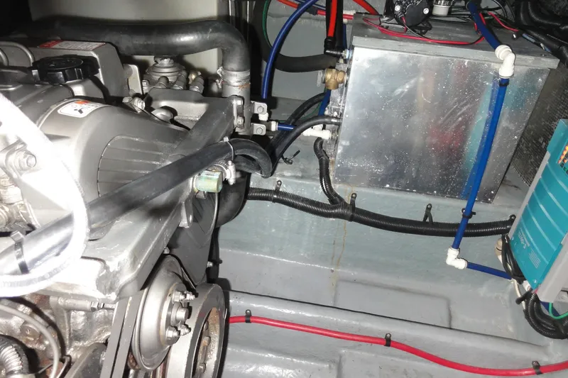 Slide: The Image of Engine compartment of a 1997 Sea Ray 330 Express boat, showing mechanical components and wiring. - 38