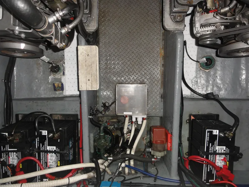 Slide: The Image of 1997 Sea Ray 330 Express engine compartment with batteries and mechanical components. - 39