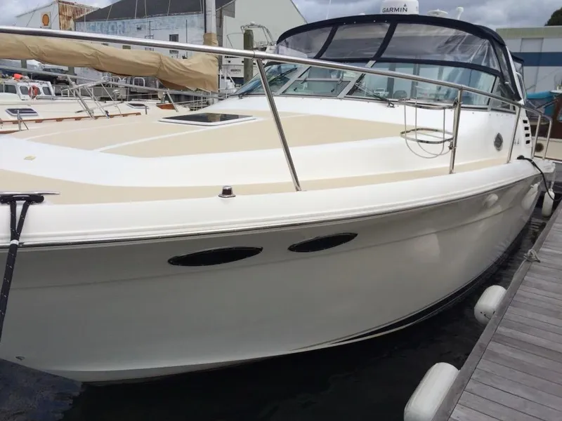 Slide: The Image of 1997 Sea Ray 330 Express boat docked at marina, showcasing sleek design and spacious deck. - 5