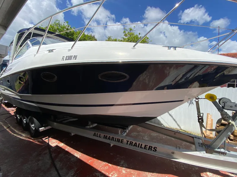 Slide: The Image of 2006 Doral 310 Intrigue boat on trailer under blue sky. - 10