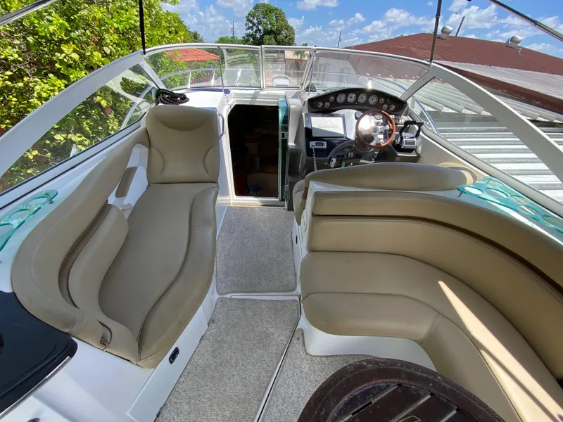 Slide: The Image of 2006 Doral 310 Intrigue boat interior with beige seating and modern dashboard. - 16