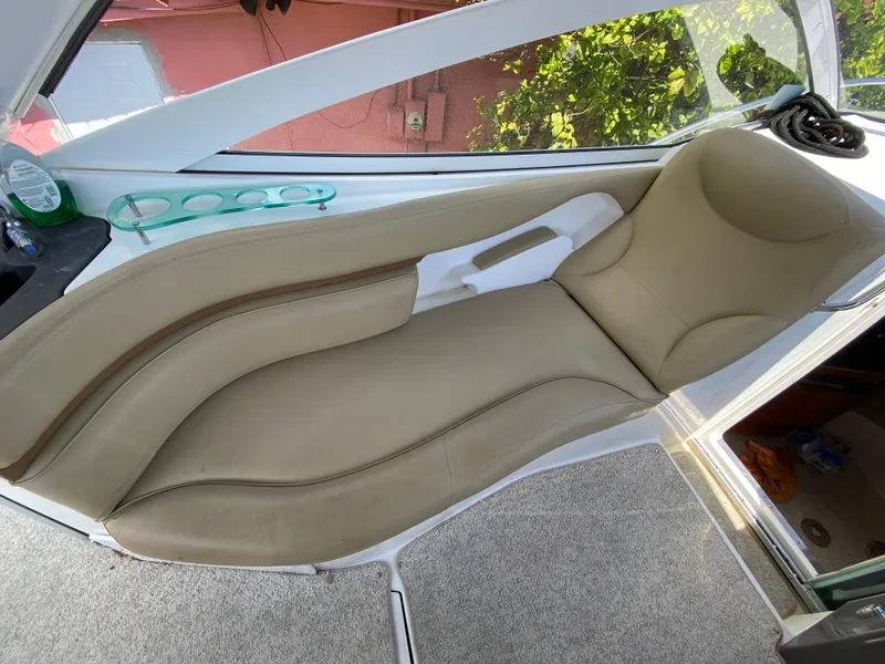 Slide: The Image of 2006 Doral 310 Intrigue boat interior with beige seating and cup holders. - 17