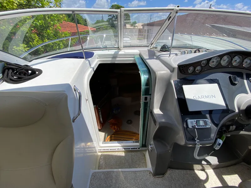 Slide: The Image of 2006 Doral 310 Intrigue boat cockpit with open cabin door and Garmin navigation system. - 20
