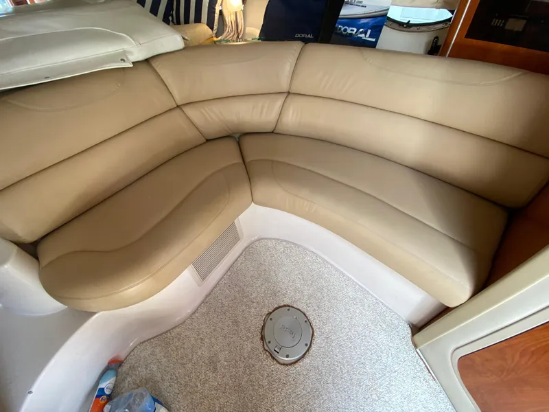 Slide: The Image of 2006 Doral 310 Intrigue boat interior with beige leather seating and carpeted floor. - 22