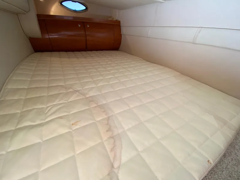Slide: The Image of 2006 Doral 310 Intrigue cabin interior with bed and wooden cabinets. - 23