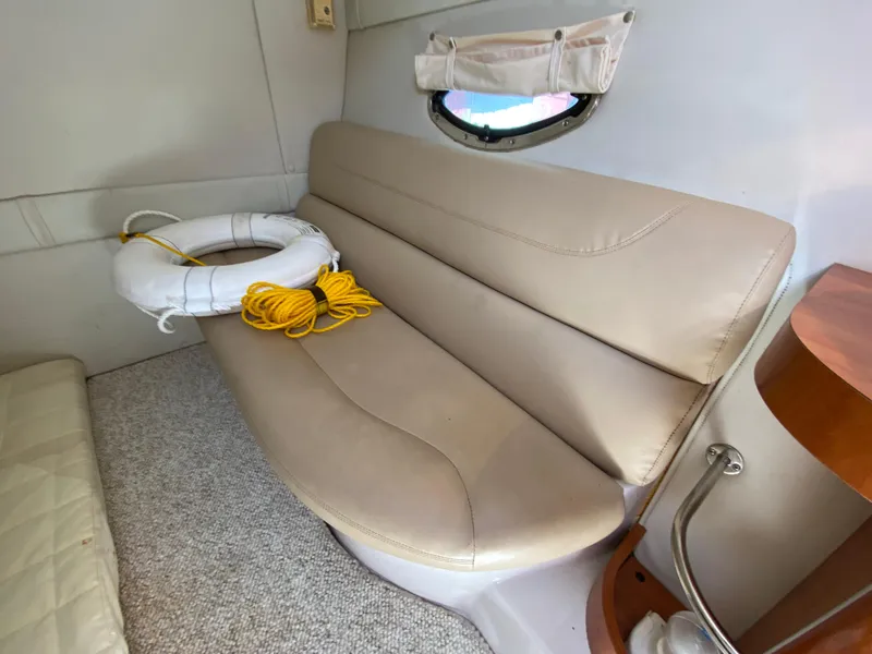Slide: The Image of 2006 Doral 310 Intrigue interior with beige seating and life preserver. - 24