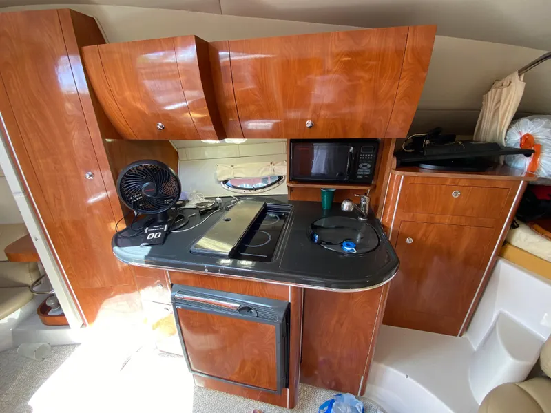 Slide: The Image of 2006 Doral 310 Intrigue yacht kitchen with wooden cabinets and modern appliances. - 25
