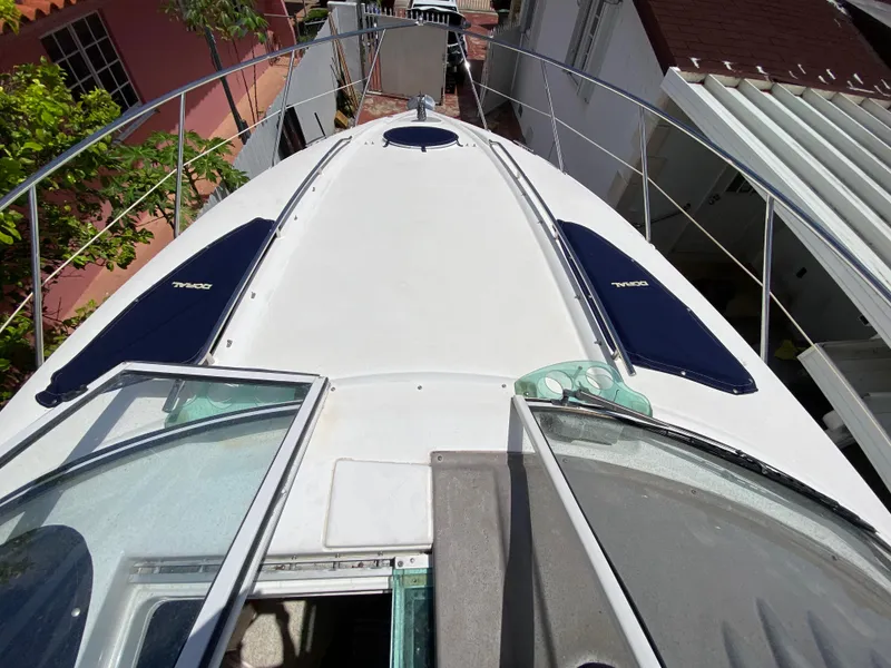 Slide: The Image of 2006 Doral 310 Intrigue boat deck view with open hatch and railing. - 27