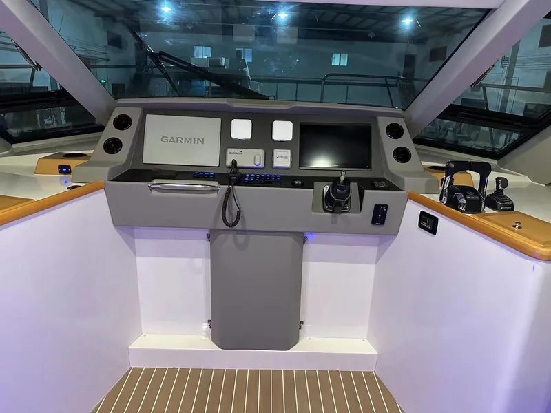 Slide: The Image of 2025 ArrowCat 420 Flybridge helm with Garmin navigation system and modern controls. - 10