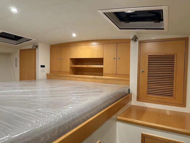 Slide: The Image of Luxurious cabin interior of 2025 ArrowCat 420 Flybridge with wooden cabinetry and spacious bed. - 3