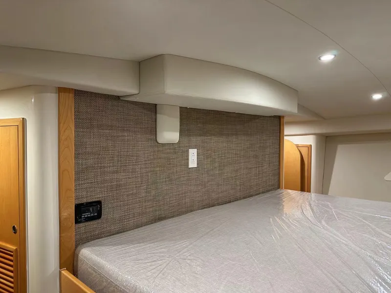 Slide: The Image of 2025 ArrowCat 420 Flybridge interior cabin with modern design and comfortable bedding. - 4