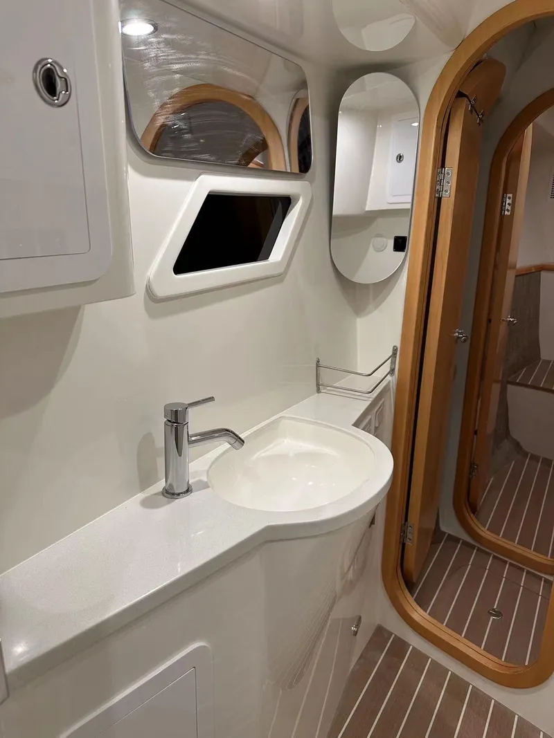 Slide: The Image of Modern bathroom in 2025 ArrowCat 420 Flybridge yacht with sleek fixtures and wooden accents. - 5
