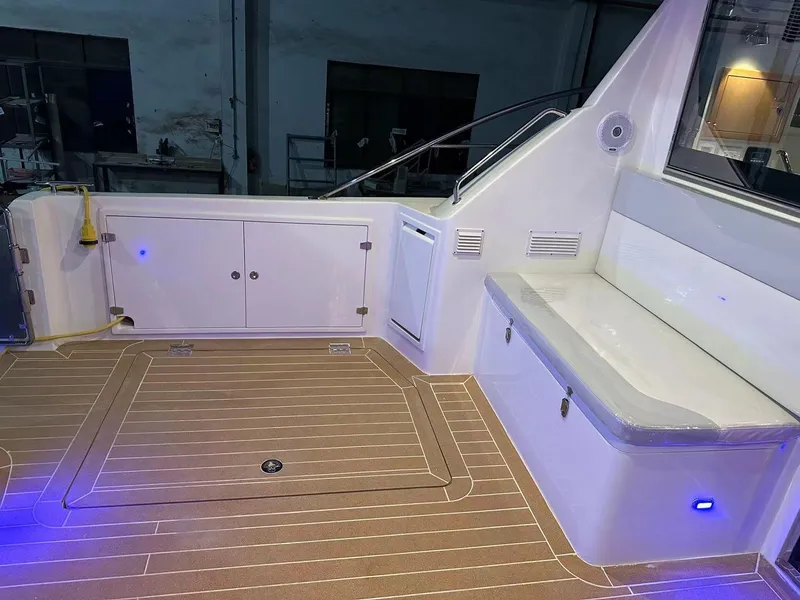 Slide: The Image of 2025 ArrowCat 420 Flybridge interior with seating and storage, featuring modern lighting. - 8