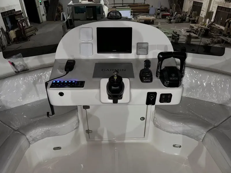 Slide: The Image of 2025 ArrowCat 420 Flybridge helm with Garmin navigation and modern controls in a spacious interior. - 9