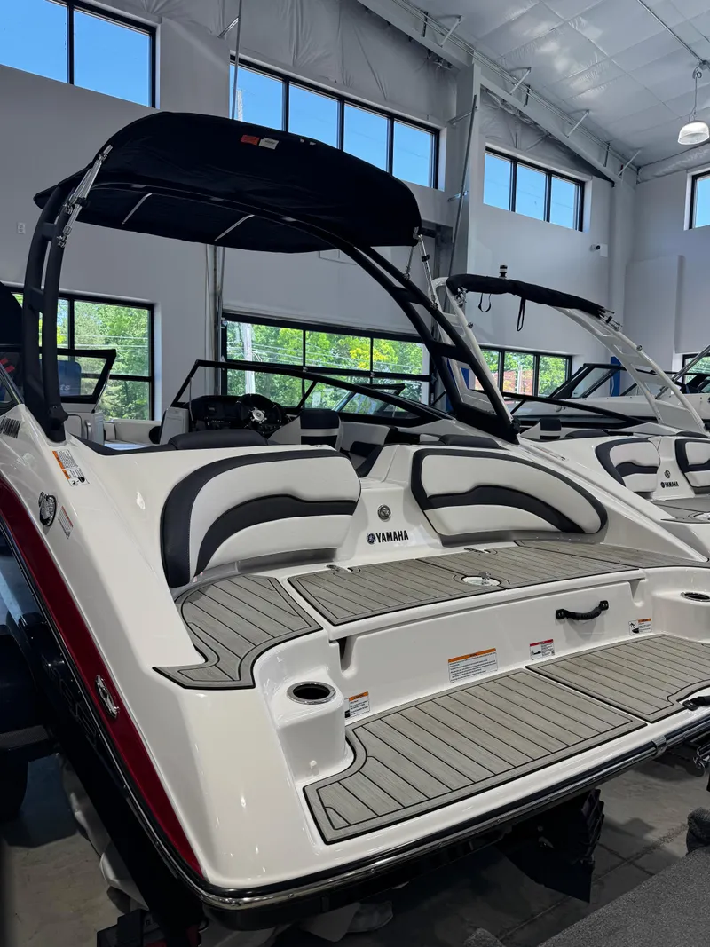 Slide: The Image of 2025 Yamaha Boats AR195 in showroom, featuring sleek design and modern interior. - 2