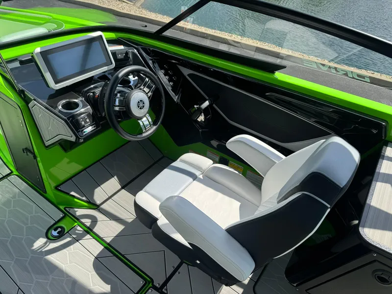 Slide: The Image of 2022 Yamaha Boats 255XD cockpit with green accents, modern steering, and touchscreen display. - 10