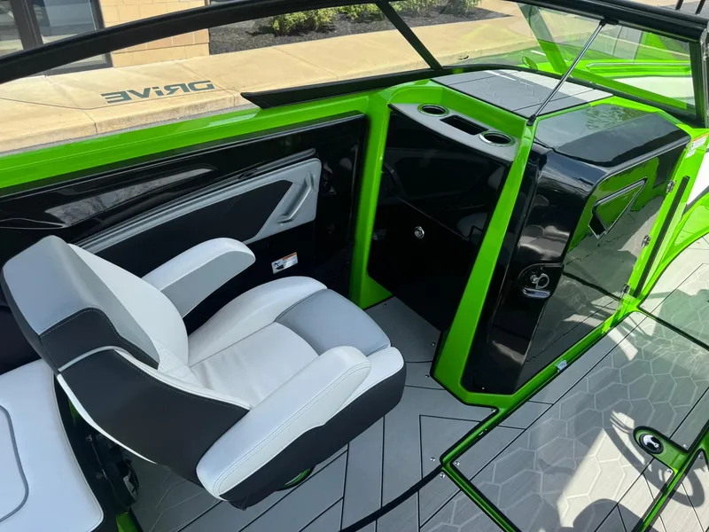 Slide: The Image of 2022 Yamaha Boats 255XD interior with green accents and modern seating design. - 11