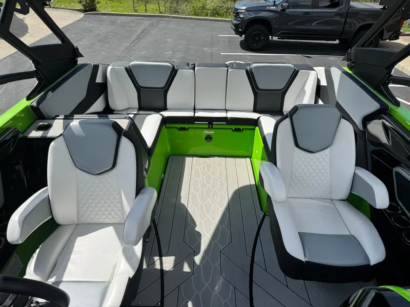 Slide: The Image of 2022 Yamaha Boats 255XD interior with white and gray seating, green accents, and modern design. - 12