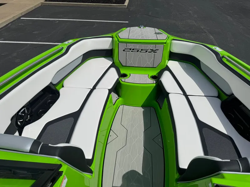 Slide: The Image of 2022 Yamaha Boats 255XD interior with green and white seating, showcasing modern design. - 13