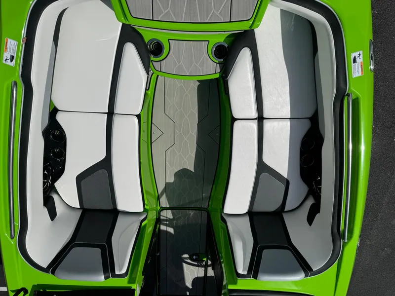Slide: The Image of 2022 Yamaha Boats 255XD interior with green accents and dual seating layout. - 14