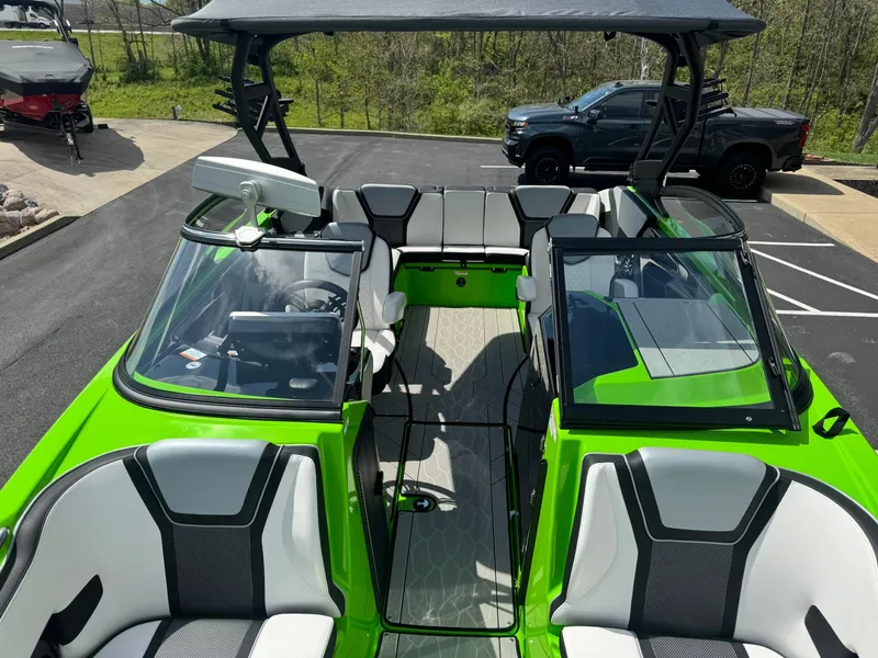 Slide: The Image of 2022 Yamaha Boats 255XD with vibrant green exterior and spacious seating. - 16
