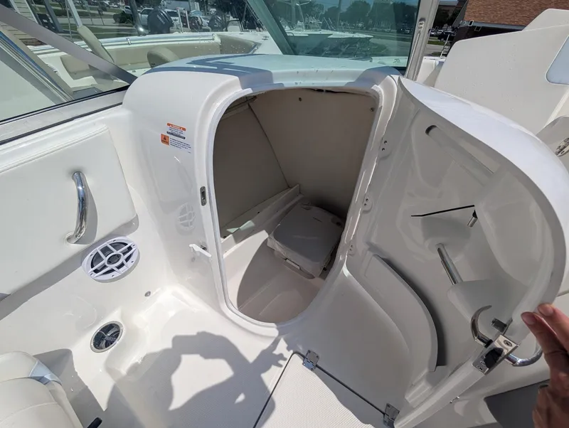 Slide: The Image of 2025 Robalo R207 Dual Console boat interior with open storage compartment. - 11