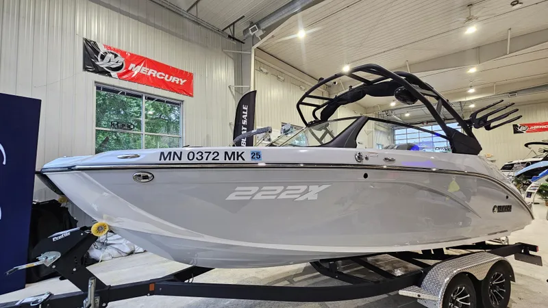 The Image of 2023 Yamaha Boats 222XD displayed indoors on a trailer. - 1