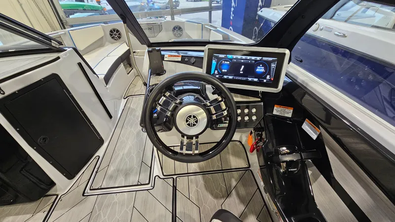 Slide: The Image of 2023 Yamaha Boats 222XD cockpit with modern steering and digital display. - 13