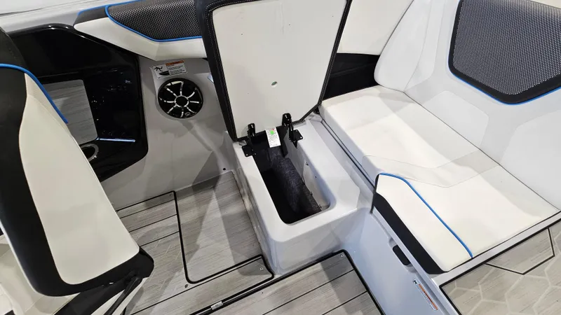 Slide: The Image of 2023 Yamaha Boats 222XD interior seating with storage compartment open. - 25